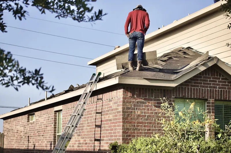 Professional roofer working on a residential roof in Flanders